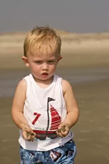 USA; Georgia; Little boy playing in the sand on the beach at Tybee island GA. (MR)