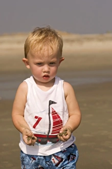 Images Dated 16th September 2006: USA; Georgia; Little boy playing in the sand on the beach at Tybee island GA. (MR)