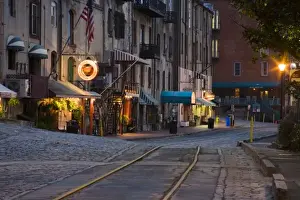 Images Dated 22nd March 2007: USA, Georgia, Savannah. Scenic view of the cobblestone River Street at night in