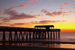 Joanne Wells Prints: USA, Georgia. Silhouette of a pier in the sunrise, near Savannah