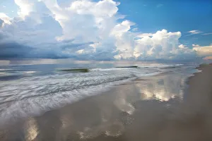 Images Dated 19th March 2022: USA, Georgia, Tybee Island. Sunrise with clouds and reflections along the coast