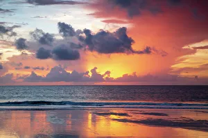 Images Dated 19th March 2022: USA, Georgia, Tybee Island. Sunrise with reflections and clouds