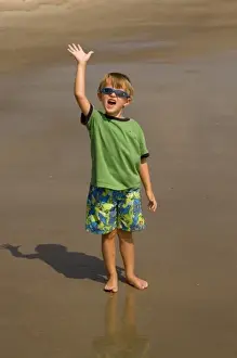 Tybee Island Prints: USA; Georgia; Young boy playing on the beach at Tybee Island GA. (MR)