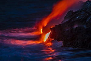 USA, Hawaii, The Big Island, Kilauea. Molten lava flowing into ocean at night. Credit as