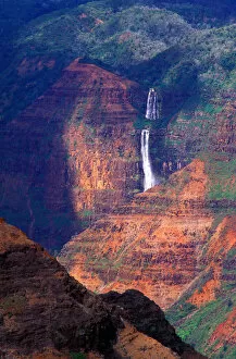 USA, Hawaii, Kauai Island, Waterfall cascading down the canyon walls in the wildlands