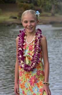 USA, Hawaii, Kauai, Smith Family Luau, girl tourist with lei at luau. (MR) (RF)