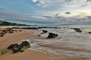 Lava Prints: USA, Hawaii, Maui. Keawakapu Beach and the white sands and wave movement over lava rocks evening light