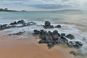 Lava Prints: USA, Hawaii, Maui. Keawakapu Beach and the white sands and wave movement over lava rocks evening light