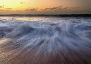 Blurred Prints: USA, Hawaii, Molokai. A long exposure blurs the sunset surf at Molokai, Hawaii