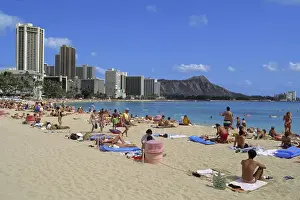 Sun Bathing Prints: USA, Hawaii, Oahu, Honolulu. Visitors enjoy the beach at Wakiki in Honolulu, Oahu, Hawaii