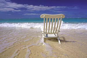 USA, Hawaiian Islands. Beach chair in surf