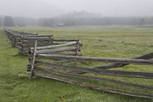 Images Dated 8th June 2005: USA, Idaho, Sawtooth Mountains. Split-rail fence divides field in misty farm country
