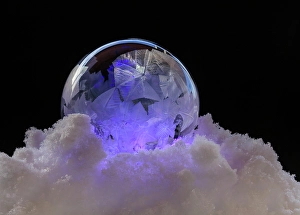 Images Dated 23rd January 2024: USA, Indiana, Carmel. Close-up of frozen soap bubble and snow