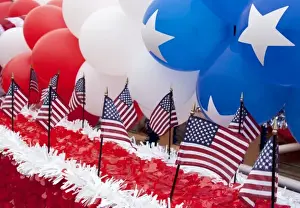 Strip Prints: USA, Indiana, Carmel. Patriotic balloons and flags decorate float in 4th of July parade