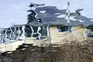 USA, Maine, Harpswell. Cottage reflected in water
