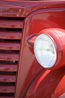 Car Prints: USA, Maine, Owls Head. Headlight and partial grill of a red antique truck. Credit as