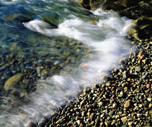Shoe Prints: USA, Maine, Waves breaking on a Rock Background