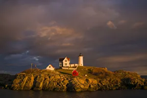 Prints of USA, Maine, York Beach, Nubble Light Lighthouse with Christmas decorations, sunset Images Dated 2016 December: USA, Maine, York Beach, Nubble Light Lighthouse with Christmas decorations, sunset