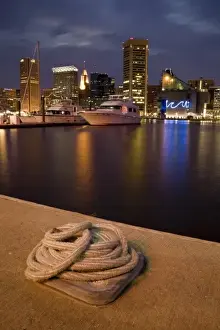 Reflecting Prints: USA, Maryland, MD, Baltimore. A rope is coiled at a dock with the city reflected