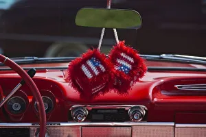 USA, Massachusetts, Gloucester. Fuzzy dice with US flag in 1950s-era convertible, antique car show