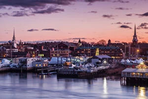 Trending: USA, Massachusetts, Newburyport, skyline from the Merrimack River at dusk