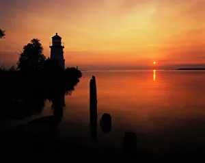 Majestic Prints: USA, Michigan, Cheboygan, View of sea and lighthouse at sunset