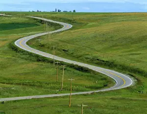 Winding Prints: USA, Montana, Browning. A rural righway snakes over the countryside near Browning
