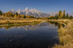 Images Dated 16th January 2022: USA, Montana, Grand Teton National Park. Grand Teton Range and stream reflects in stream