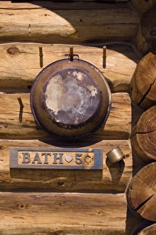 Cabin Prints: USA, Montana, Little Belt Mountains. Rusted pan and sign on outside of bath house