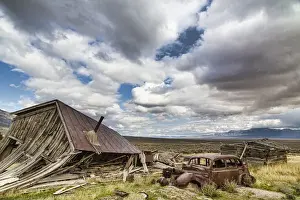 Fallen Prints: USA, Nevada, Cherry Creek. Collapsed building and rusted vintage car