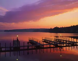 Sun Rise Prints: USA, New Hampshire. Colors of sunrise reflecting on dock and Lake Winnipesaukee