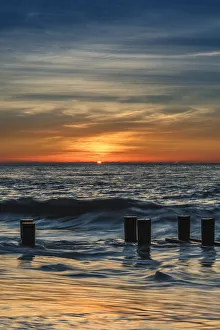 USA, New Jersey, Cape May National Seashore. Sunrise on winter shoreline. Credit as
