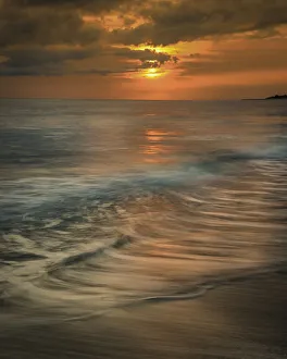 USA, New Jersey, Cape May National Seashore. Sunrise storm clouds over shoreline