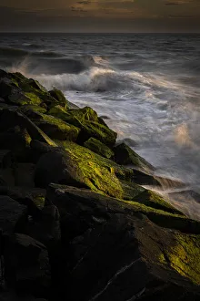 USA, New Jersey, Cape May National Seashore. Sunset on ocean and rocky shore