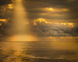 Images Dated 26th May 2021: USA, New Jersey, Cape May National Seashore. Sunlight through storm clouds over ocean