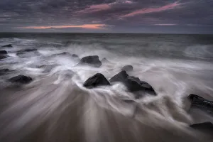 USA, New Jersey, Cape May National Seashore. Sunrise on rocky shore and ocean