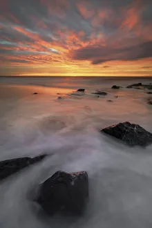 USA, New Jersey, Cape May National Seashore. Sunrise on rocky shore and ocean