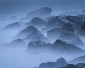 Images Dated 1st June 2021: USA, New Jersey, Cape May National Seashore. Scenic of fog-covered rocks on shore