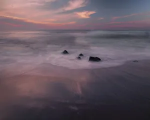 Images Dated 1st June 2021: USA, New Jersey, Cape May National Seashore. Sunrise on rocky shore and ocean