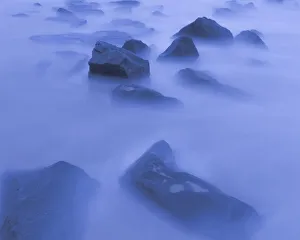Images Dated 20th April 2022: USA, New Jersey, Cape May National Seashore. Sunrise mist on rocky shore