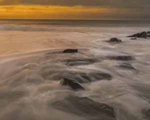Images Dated 20th April 2022: USA, New Jersey, Cape May National Seashore. Sunrise on rocky shoreline
