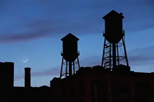 Smokestack Prints: USA, New Jersey, Jersey City, Rooftop water towers and setting crescent moon