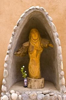 USA, New Mexico, Los Cerrillos. Religious statue in garden at St. Joseph Church