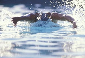 USA, New Mexico, Santa Fe. Woman swimming. (MR)