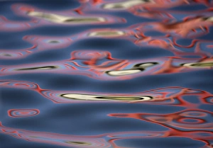 Art Morris Prints: USA, New Mexico, Socorro. Bridge reflections create abstract swirling red patterns in water
