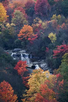 USA, New York, Adirondack Mountains. Autumn trees and waterfalls