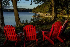 USA, New York, Adirondack State Park. Chairs on lake shore