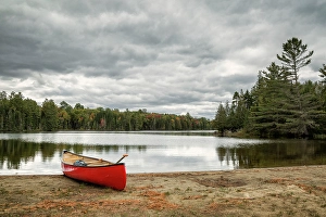 Images Dated 2025: USA, New York, Adirondacks. Lake Abanakee, Red canoe on Chain Lakes Bathing Beach