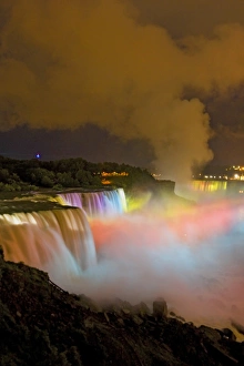 Powerful Prints: USA, New York, Niagara Falls. Nighttime view of the waterfalls and mist lit with colored lights