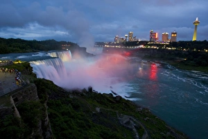 Powerful Prints: USA, New York, Niagara Falls. Tourists enjoy twilight view of American Falls in foreground